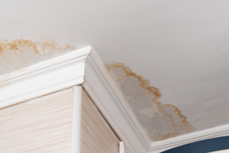 Neighbors have a water leak, water-damaged ceiling, close-up of a stain on the ceiling